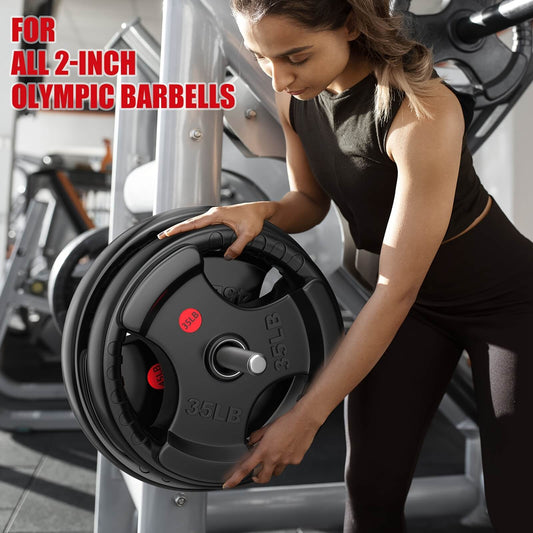 Woman lifting weight plates in a gym setting.