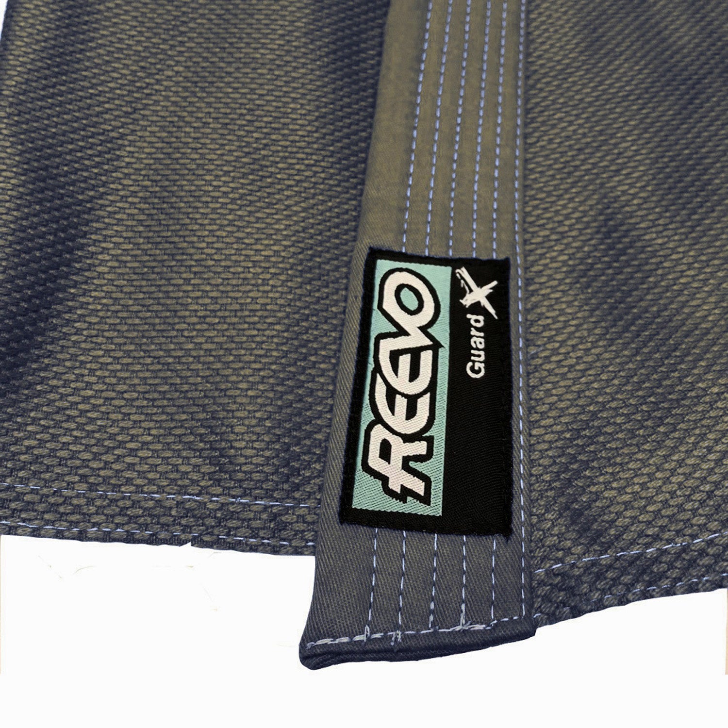 Close-up of a green fabric with a 'REEVO Guard' label on a white background