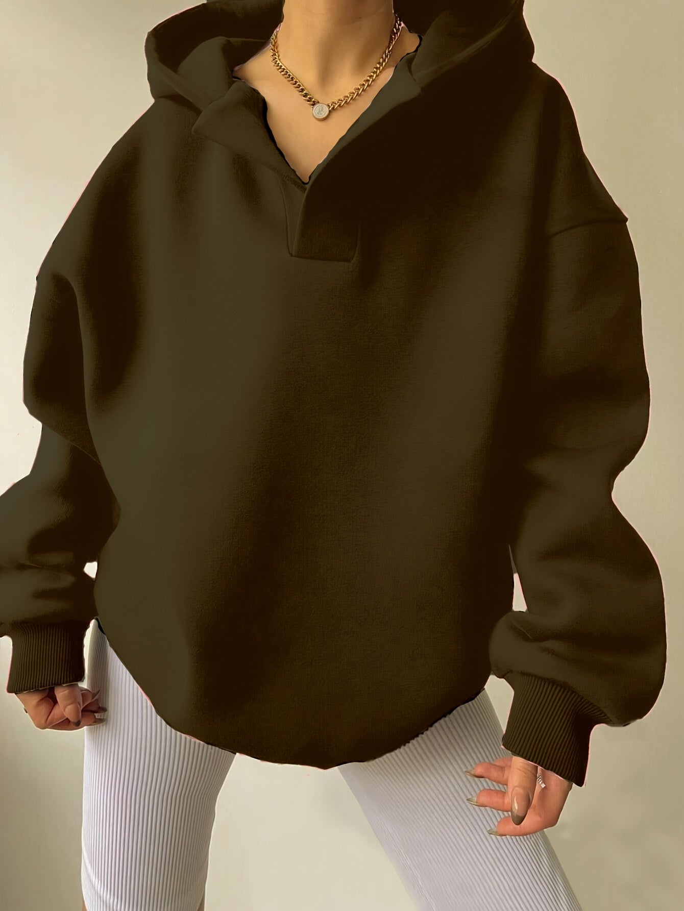 The front view of a woman wearing a camouflage winter hoodie for women sold by 100 Spartans