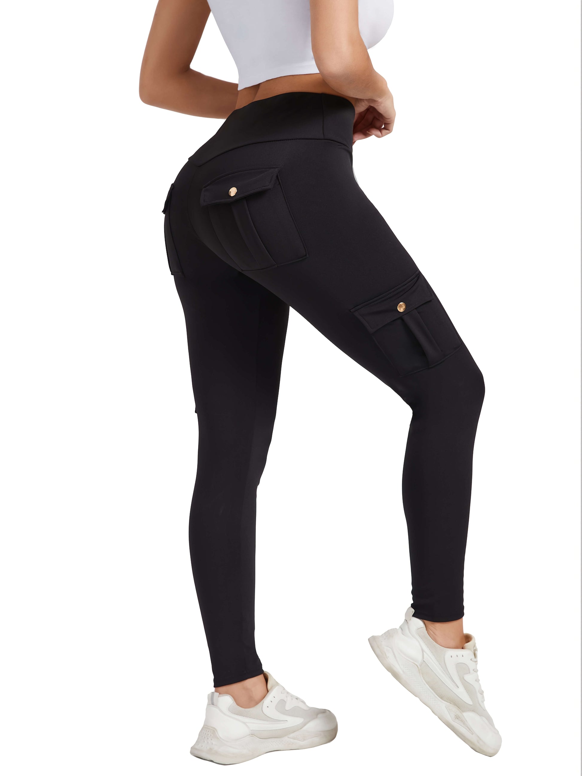 The side view of a woman wearing a pair of black yoga legging sold by 100 Spartans