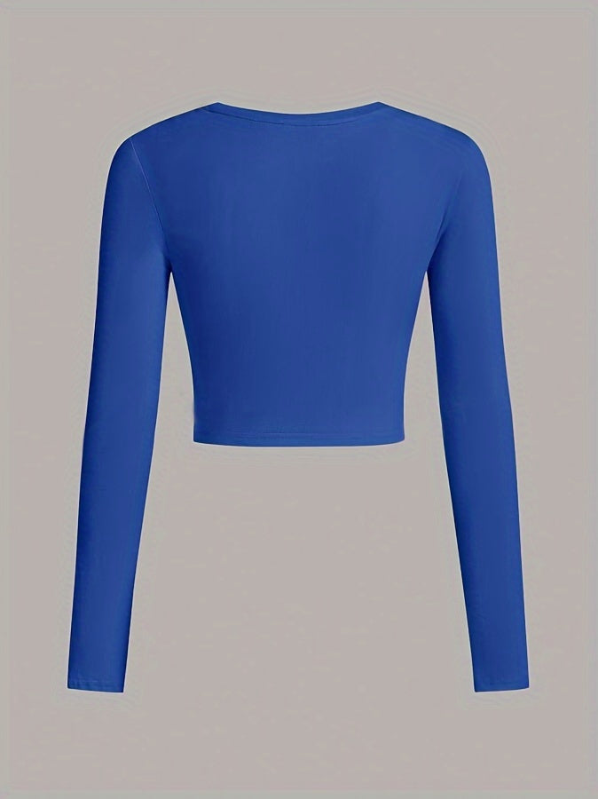 Blue long-sleeve crop top on a gray background