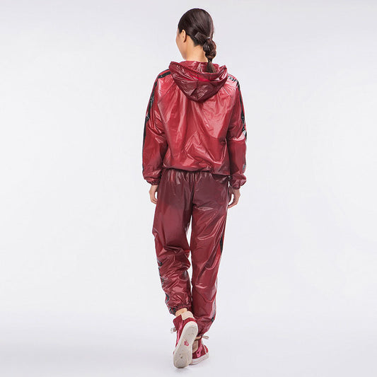 Person wearing a shiny red tracksuit on a white background