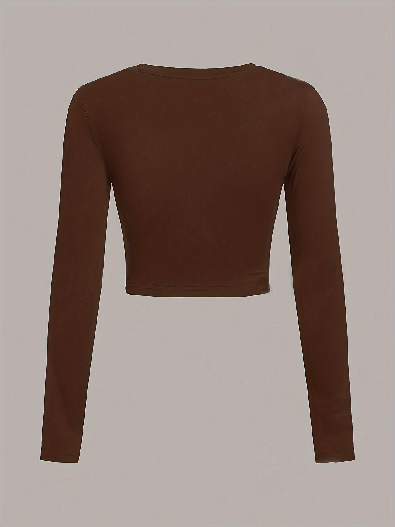 Brown long-sleeve crop top on a light gray background