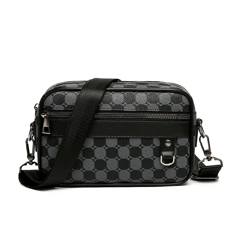 Black and gray patterned leather toiletry bag with a black strap on a white background
