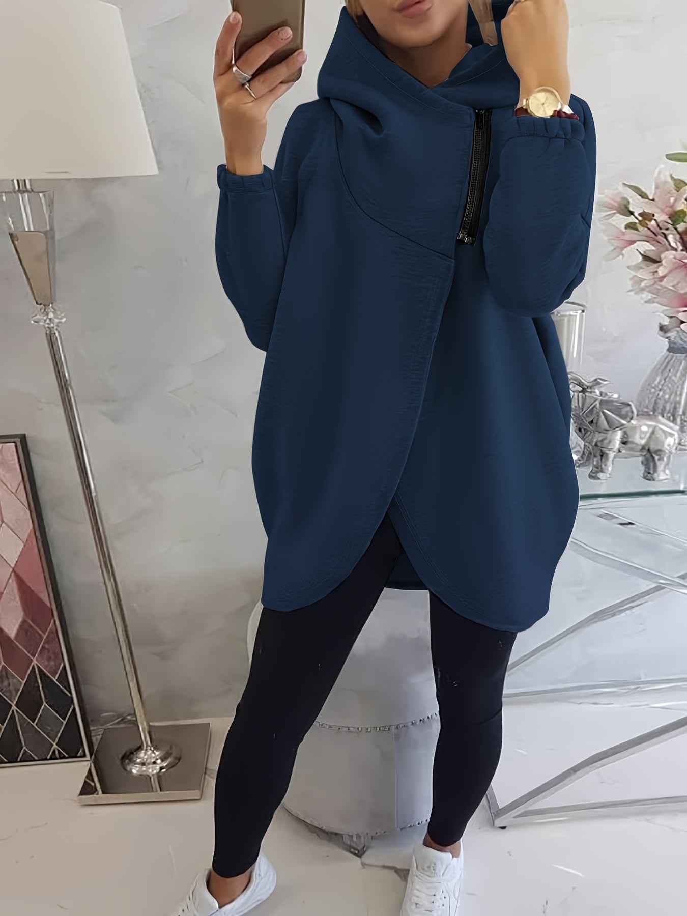 A woman wearing a blue women’s oversized zip-up hoodie