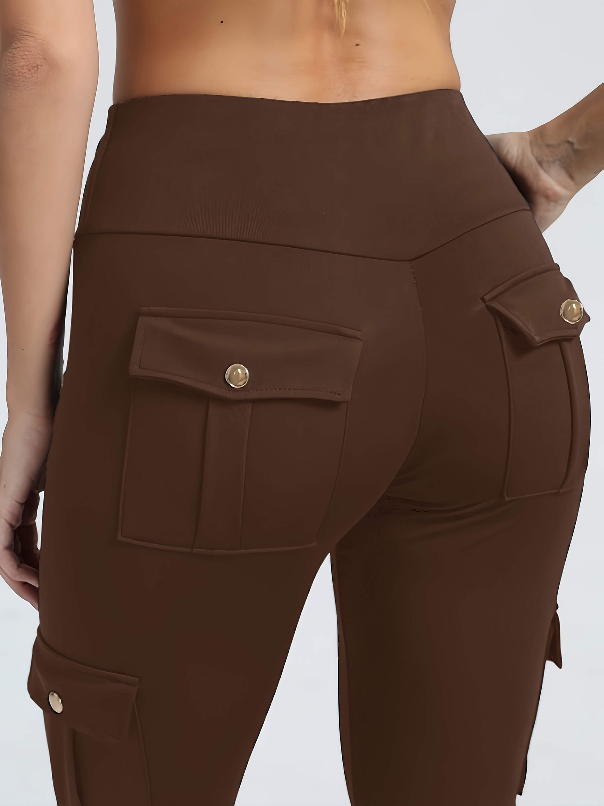 The back view of a woman wearing a pair of yoga legging sold by 100 Spartans