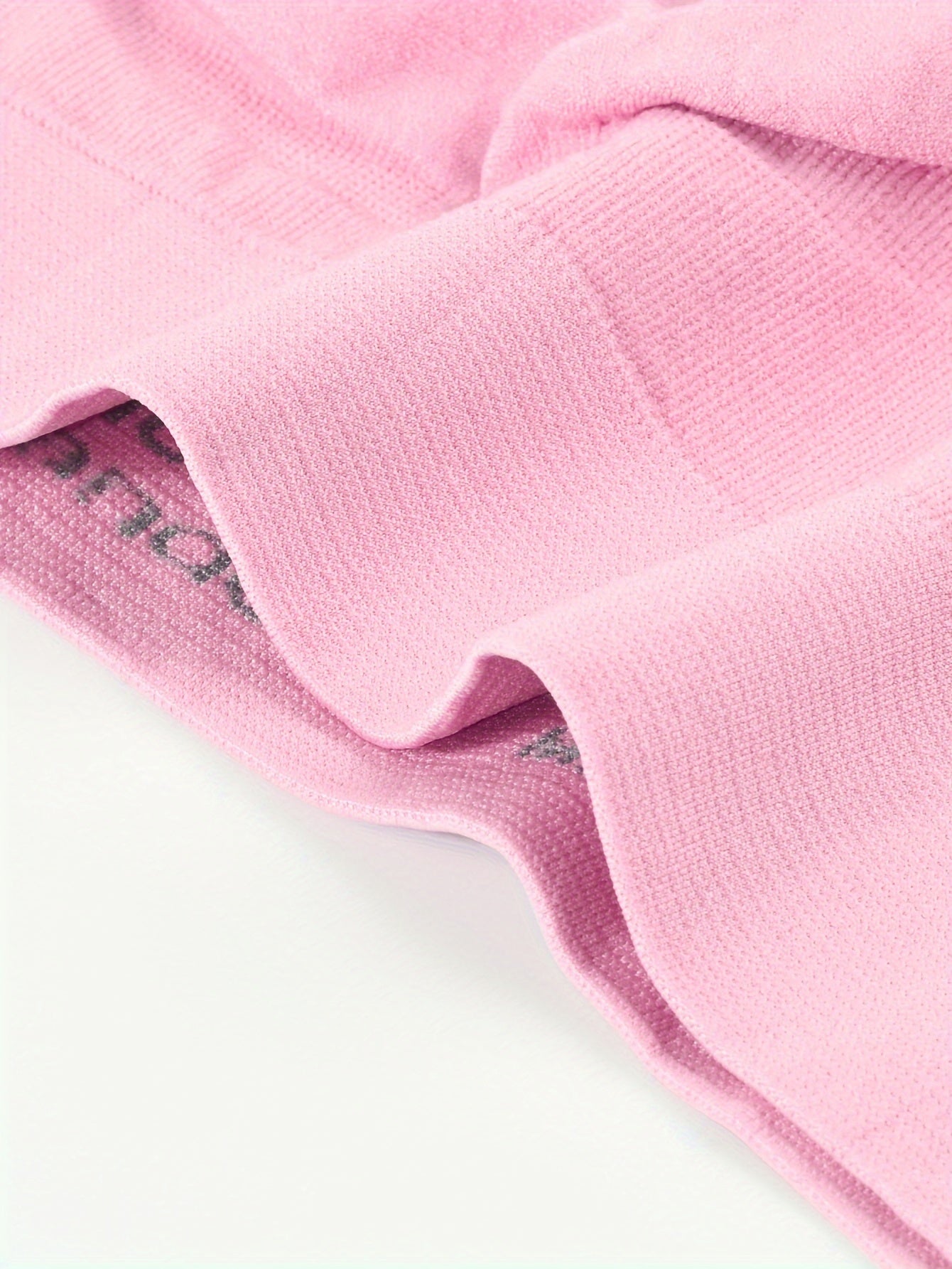 A close up of the elastic band of a pink Padded Sports Bra For Women sold by 100 Spartans on a white background