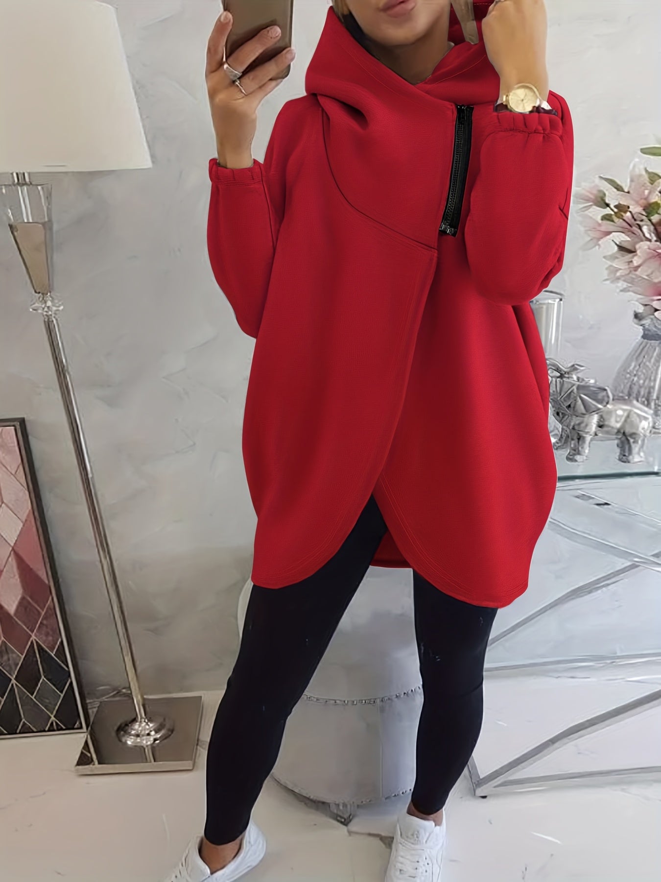 A woman wearing a red women’s oversized zip-up hoodie