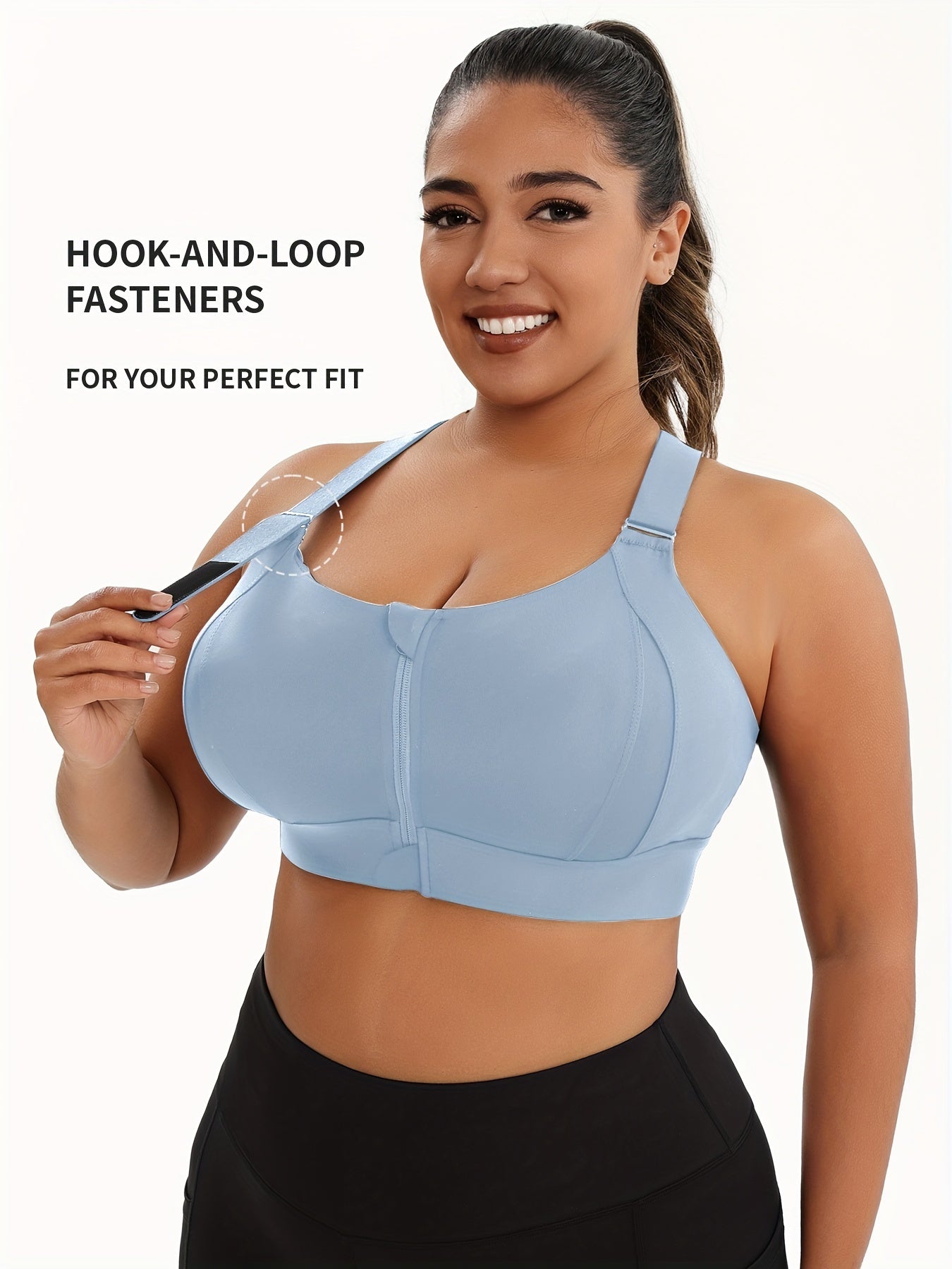 A woman wearing a light blue plus size sports bras with criss-cross back design sold by 100 Spartans