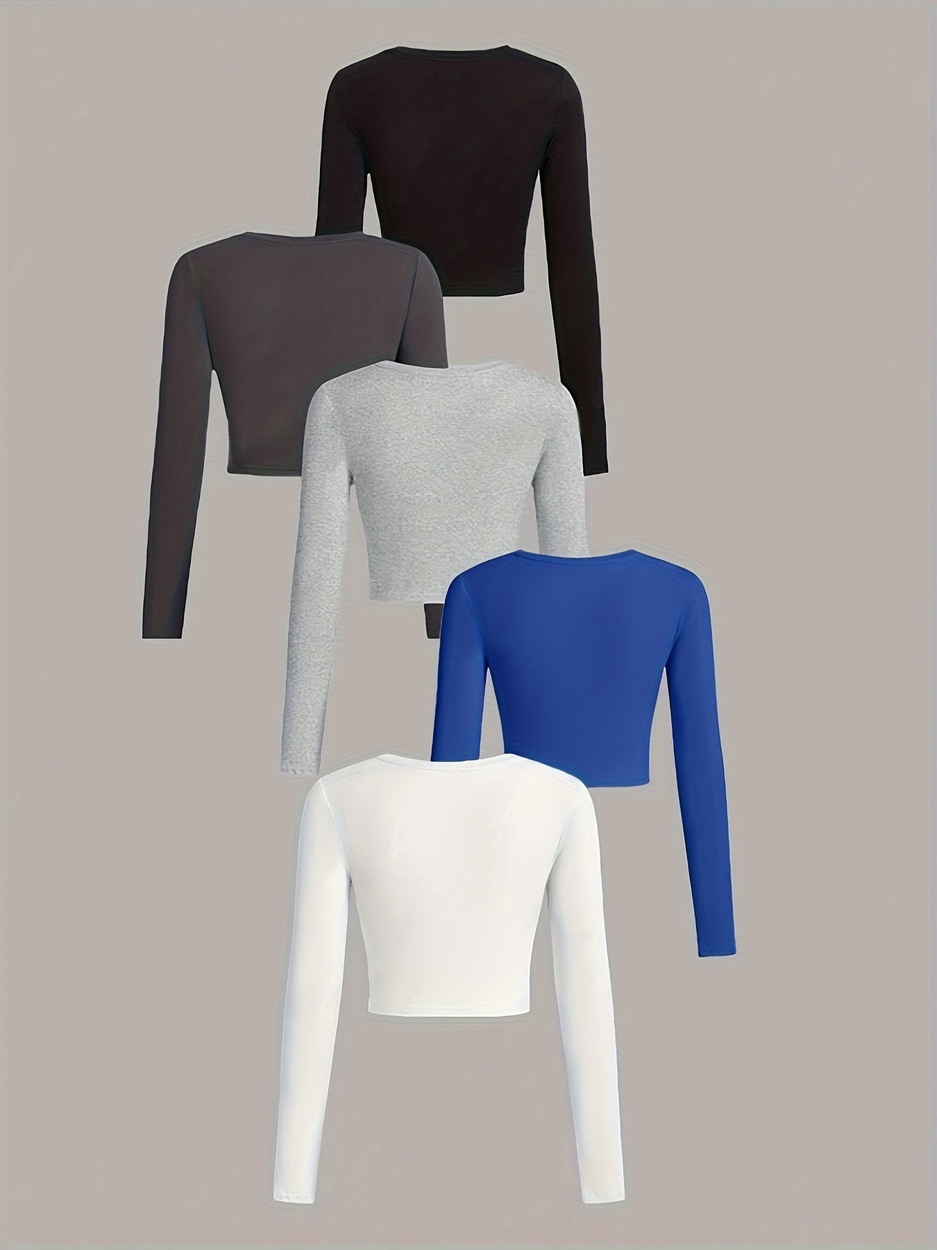 Set of five long-sleeve crop tops in black, gray, blue, white, and another color on a beige background.