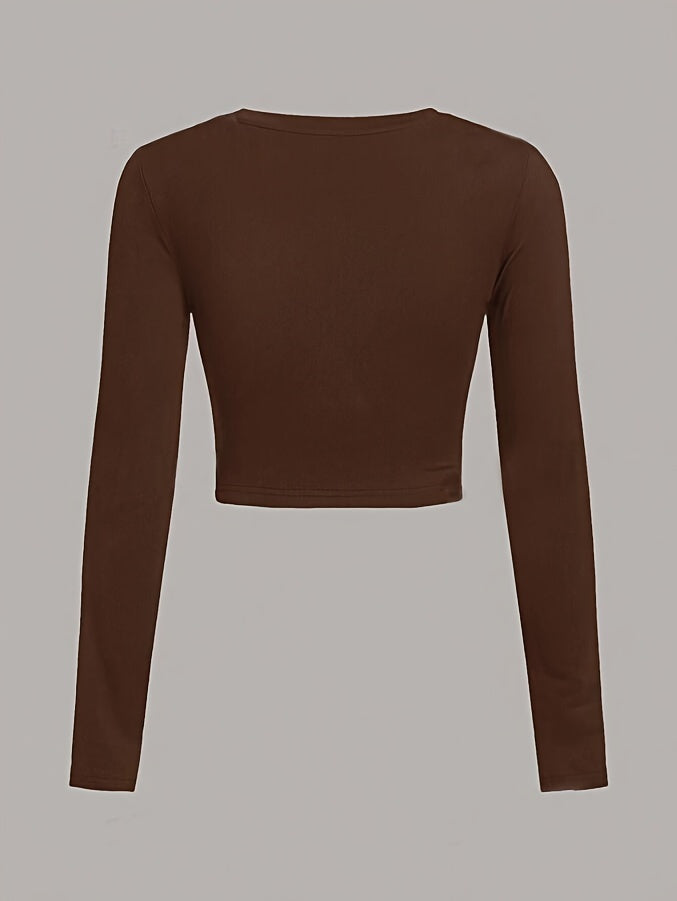 Brown long-sleeve crop top on a gray background