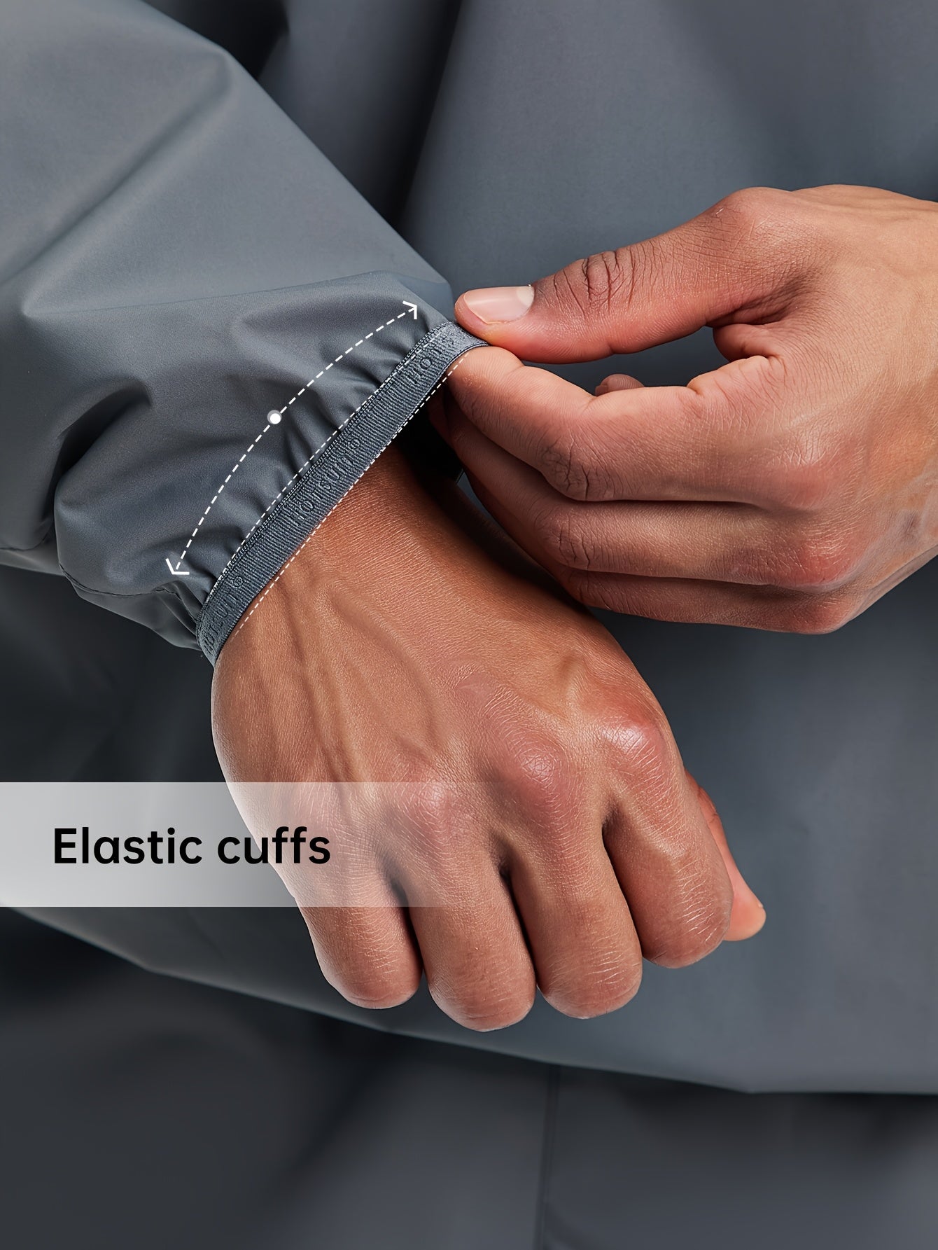 Person adjusting the elastic cuffs of a gray sauna sweat suit top with text 'Elastic cuffs'.