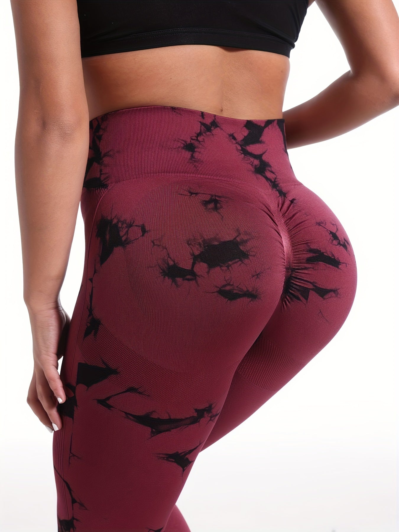 The backview of a woman wearing a red high waisted yoga leggings sold by 100 Spartans
