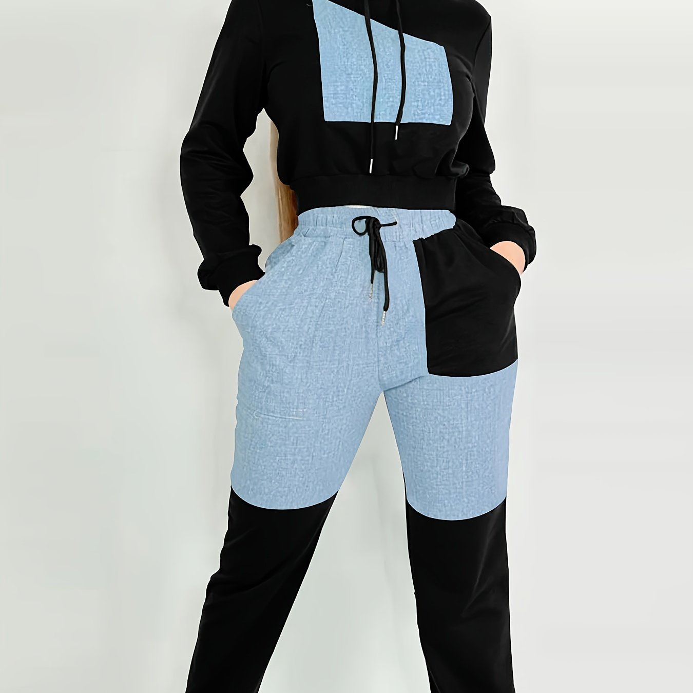 Black and light blue women's luxury tracksuit set with a hood on a white background