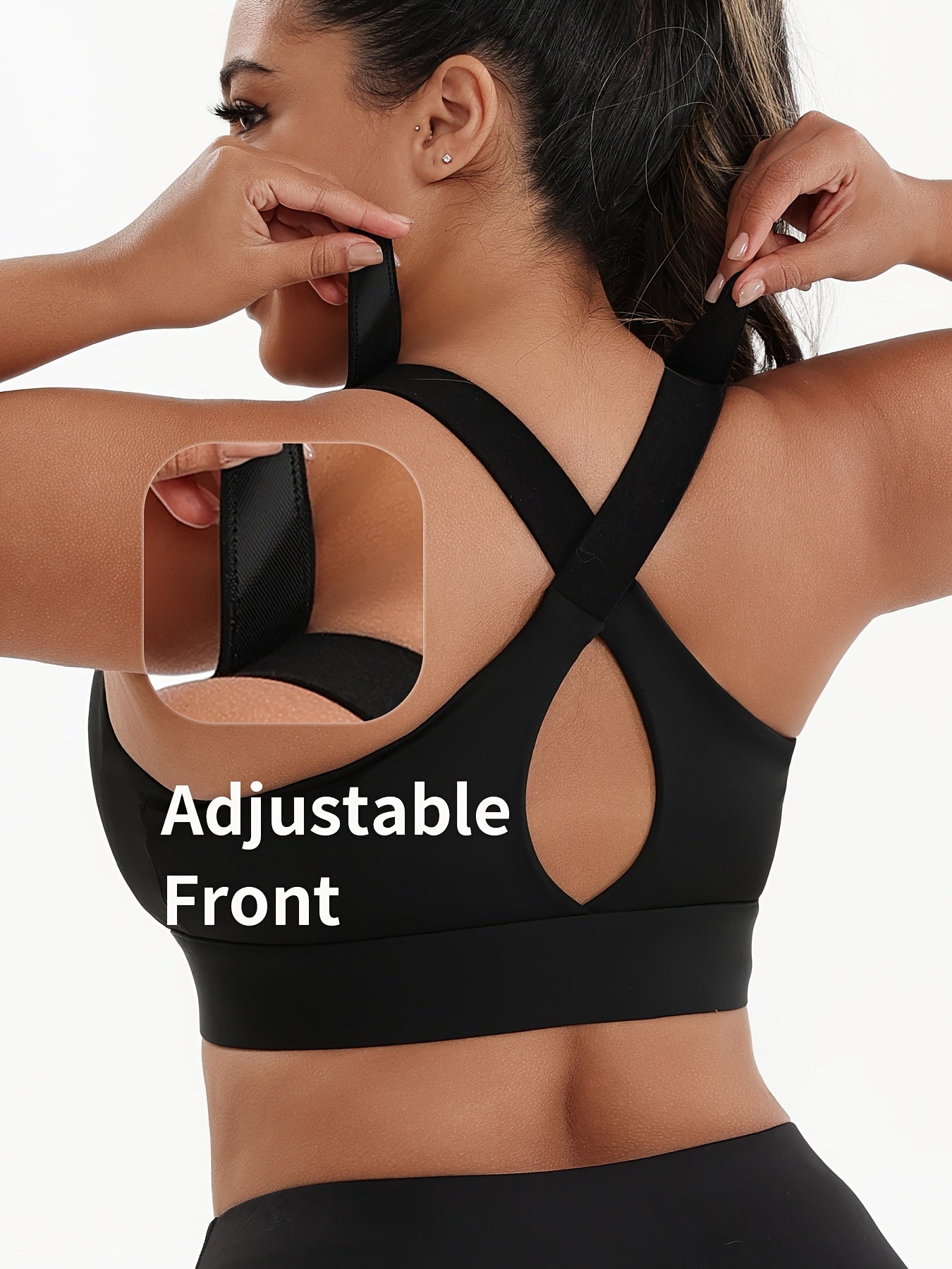 A woman wearing a black plus size sports bras with criss-cross back design sold by 100 Spartans