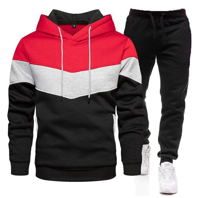 Color-blocked hoodie and black pants with white sneakers on a white background