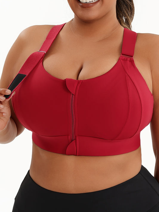 A woman wearing a red plus size sports bras with criss-cross back design sold by 100 Spartans