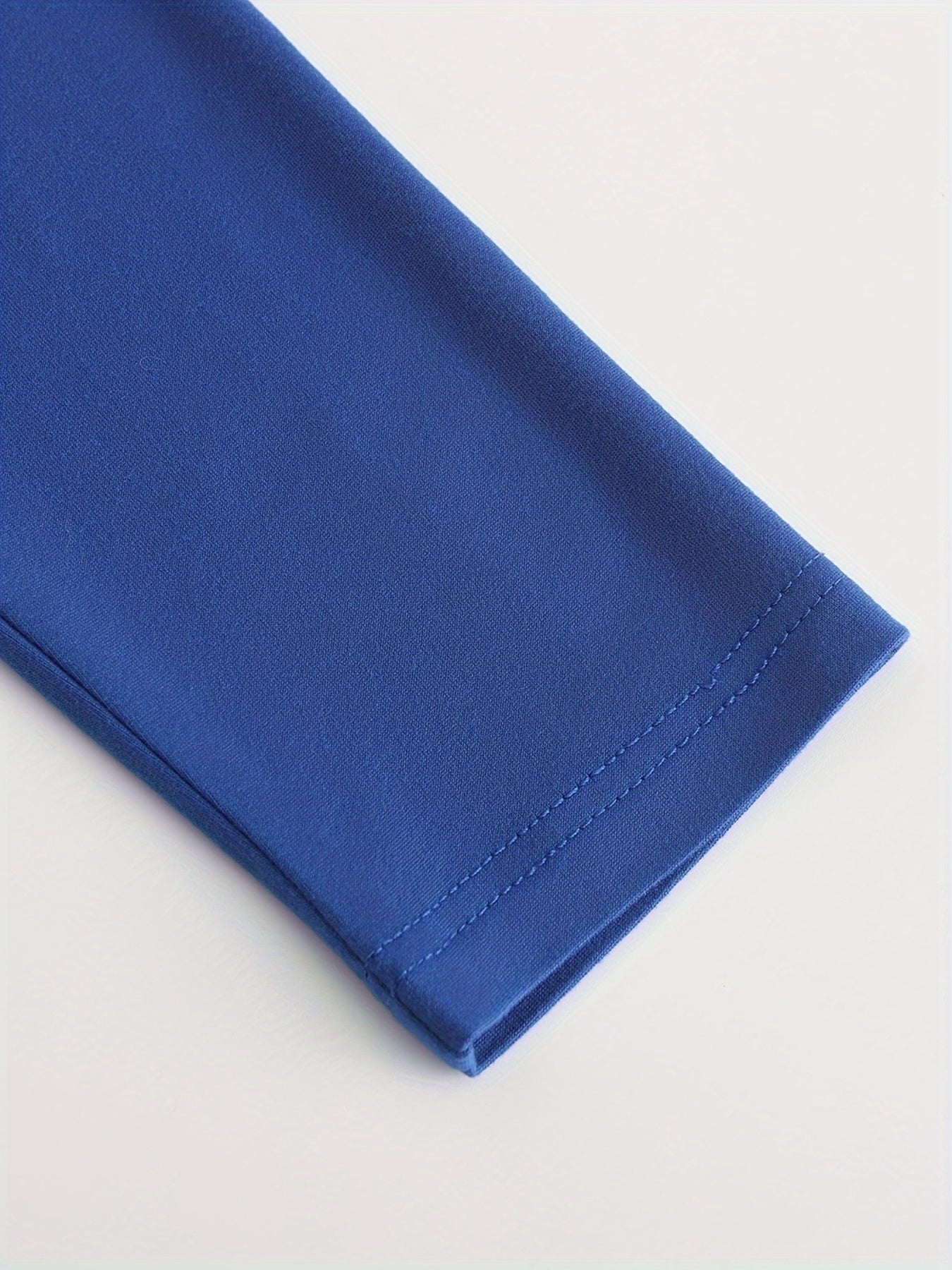 Close-up of a blue fabric edge on a white background