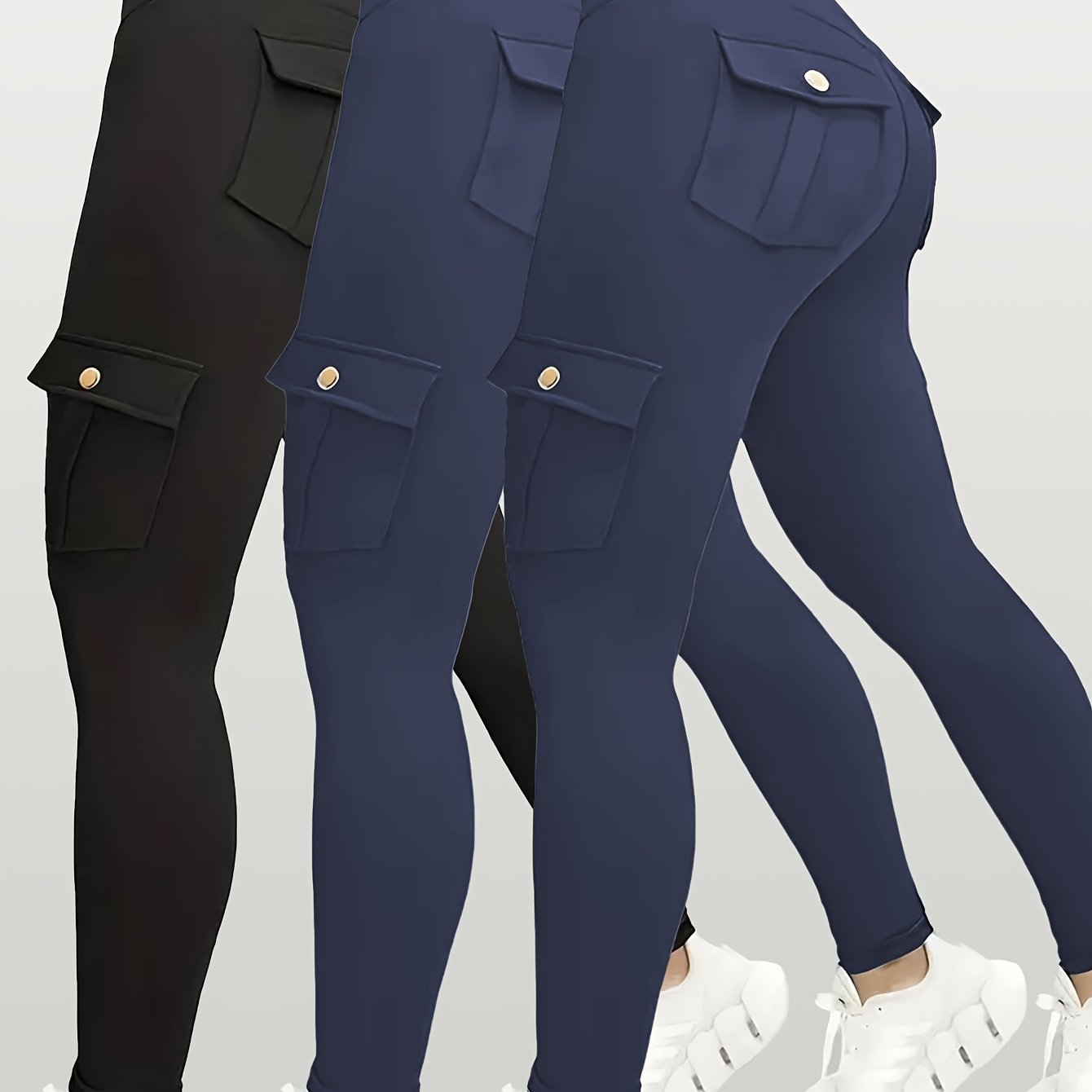 Navy and black yoga leggings with button details on a light gray background
