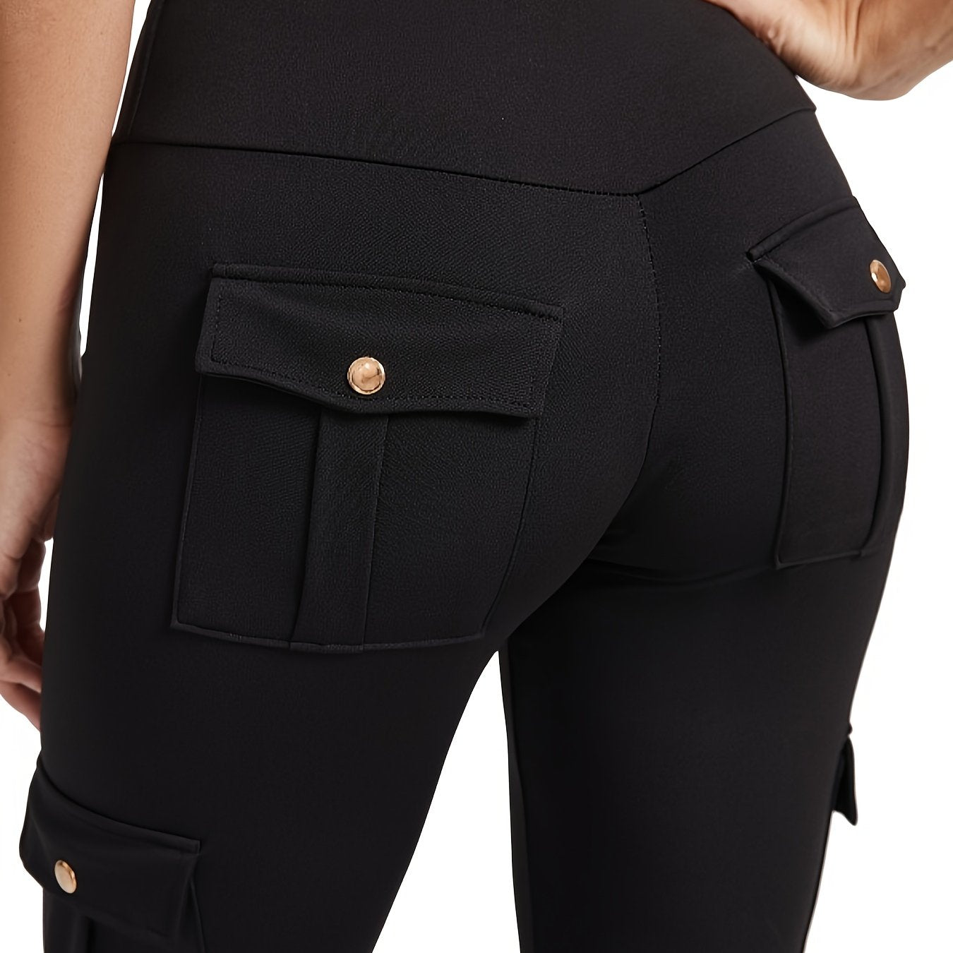 The back view of a woman wearing a pair of black yoga legging sold by 100 Spartans