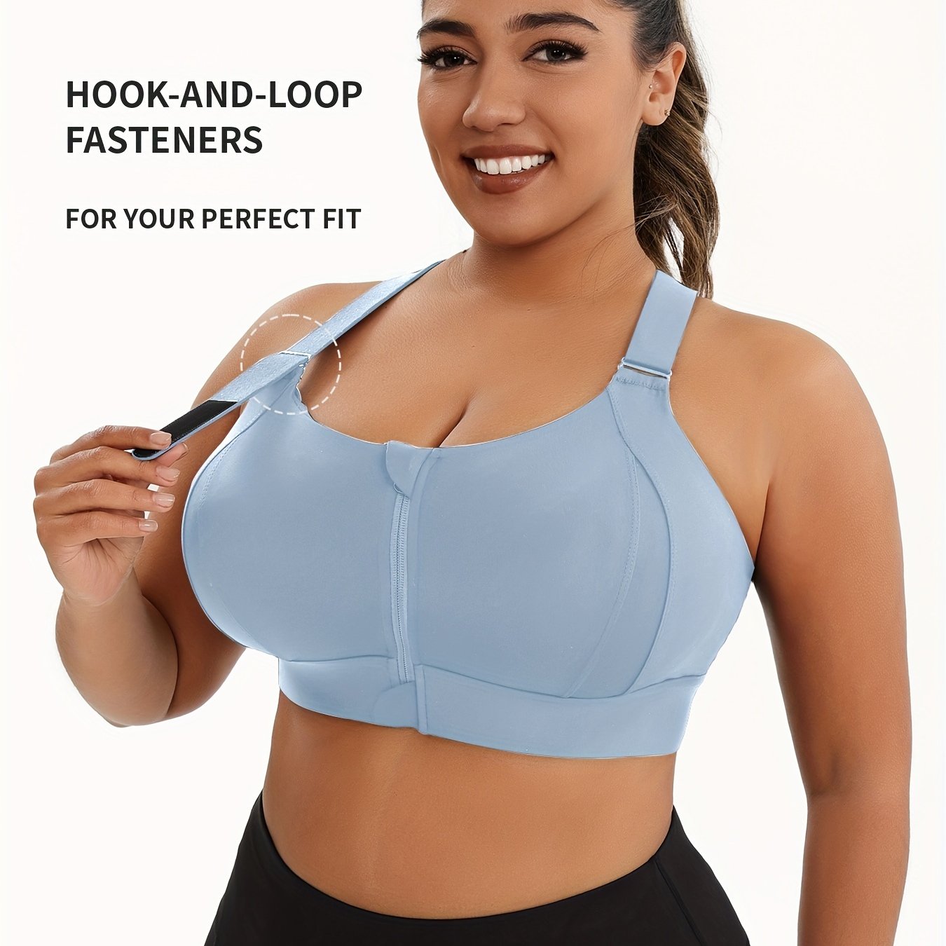 A woman wearing a light blue plus size sports bras with criss-cross back design sold by 100 Spartans