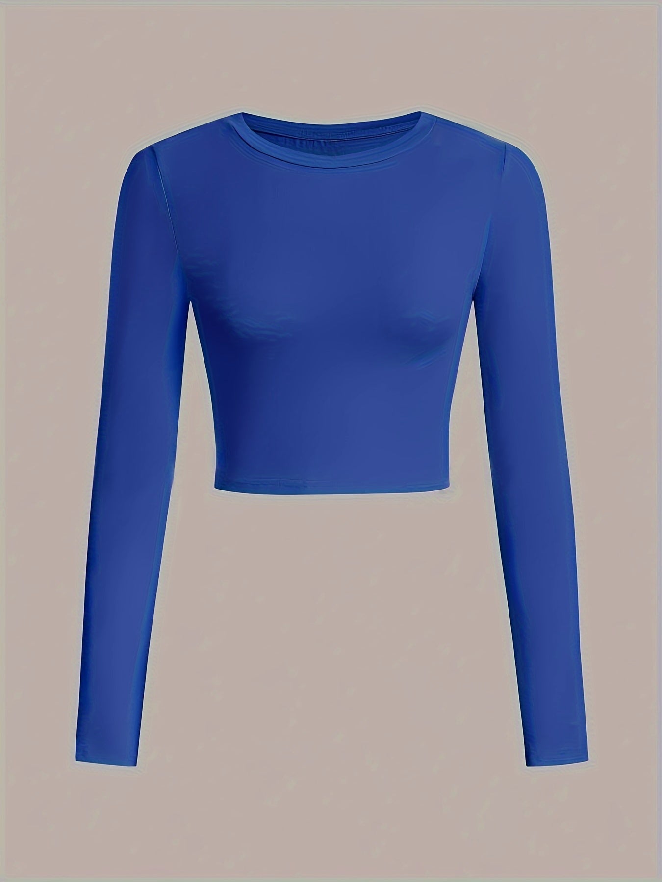 Blue long-sleeve crop top on a beige background