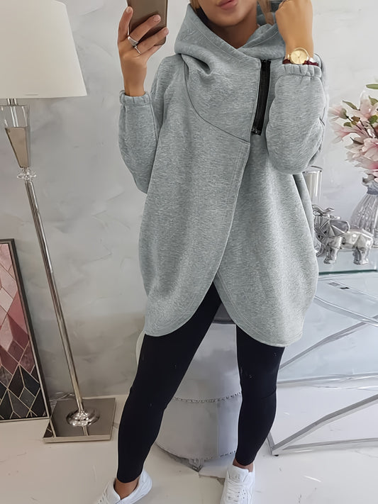 A woman wearing a grey women’s oversized zip-up hoodie