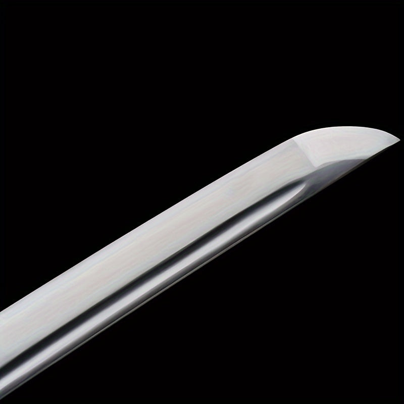 Close-up of a curved antique Japanese Samurai Katana sword blade on a black background