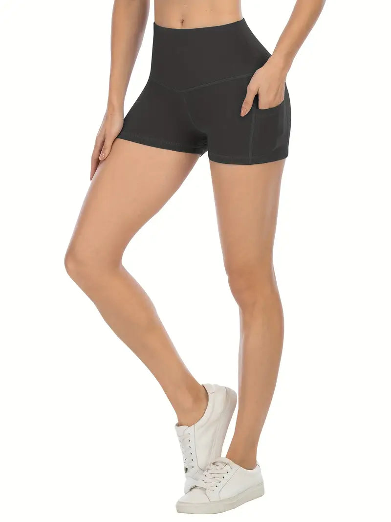 Person wearing black high-waisted shorts on a white background