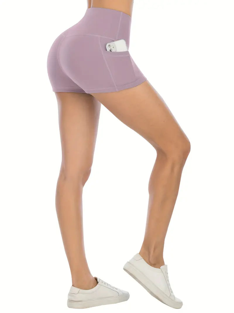 Person wearing purple biker shorts with pockets with a pocket on a white background