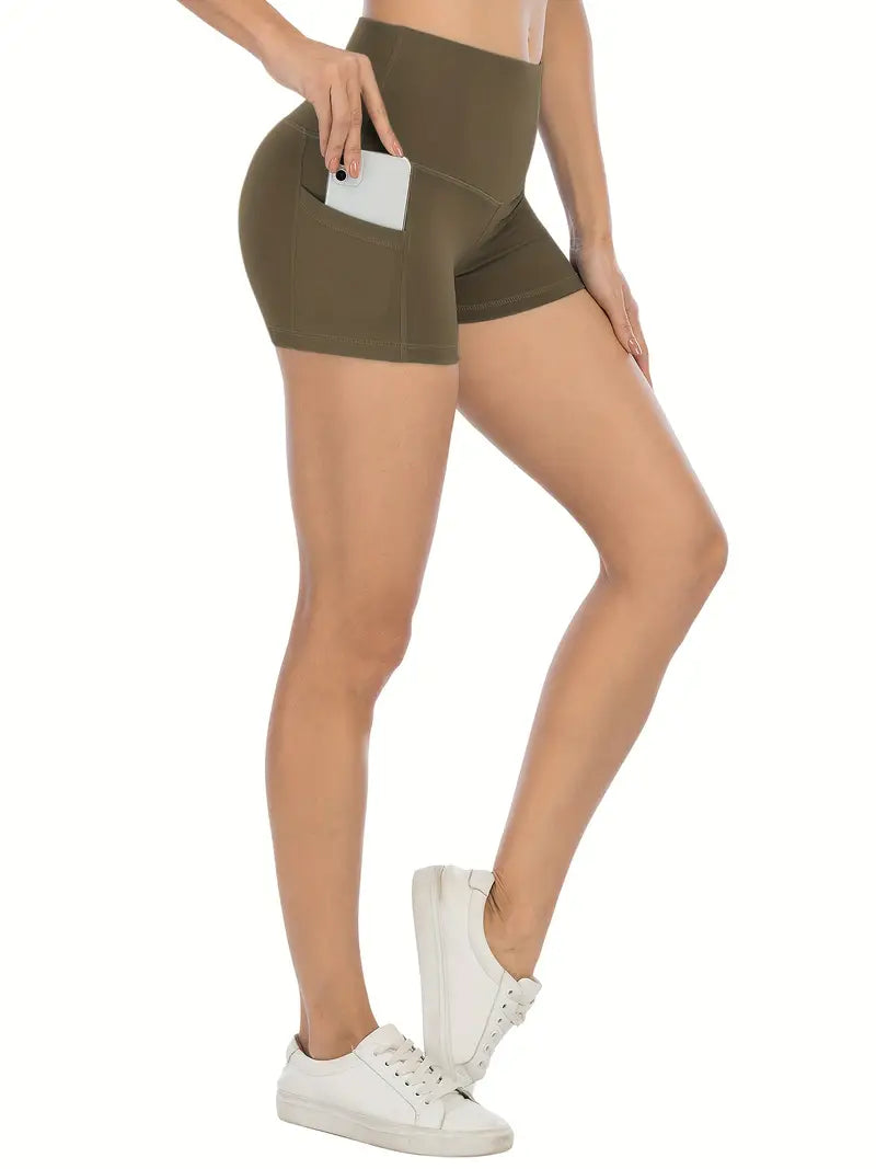 Person wearing olive green biker shorts with pockets on a white background