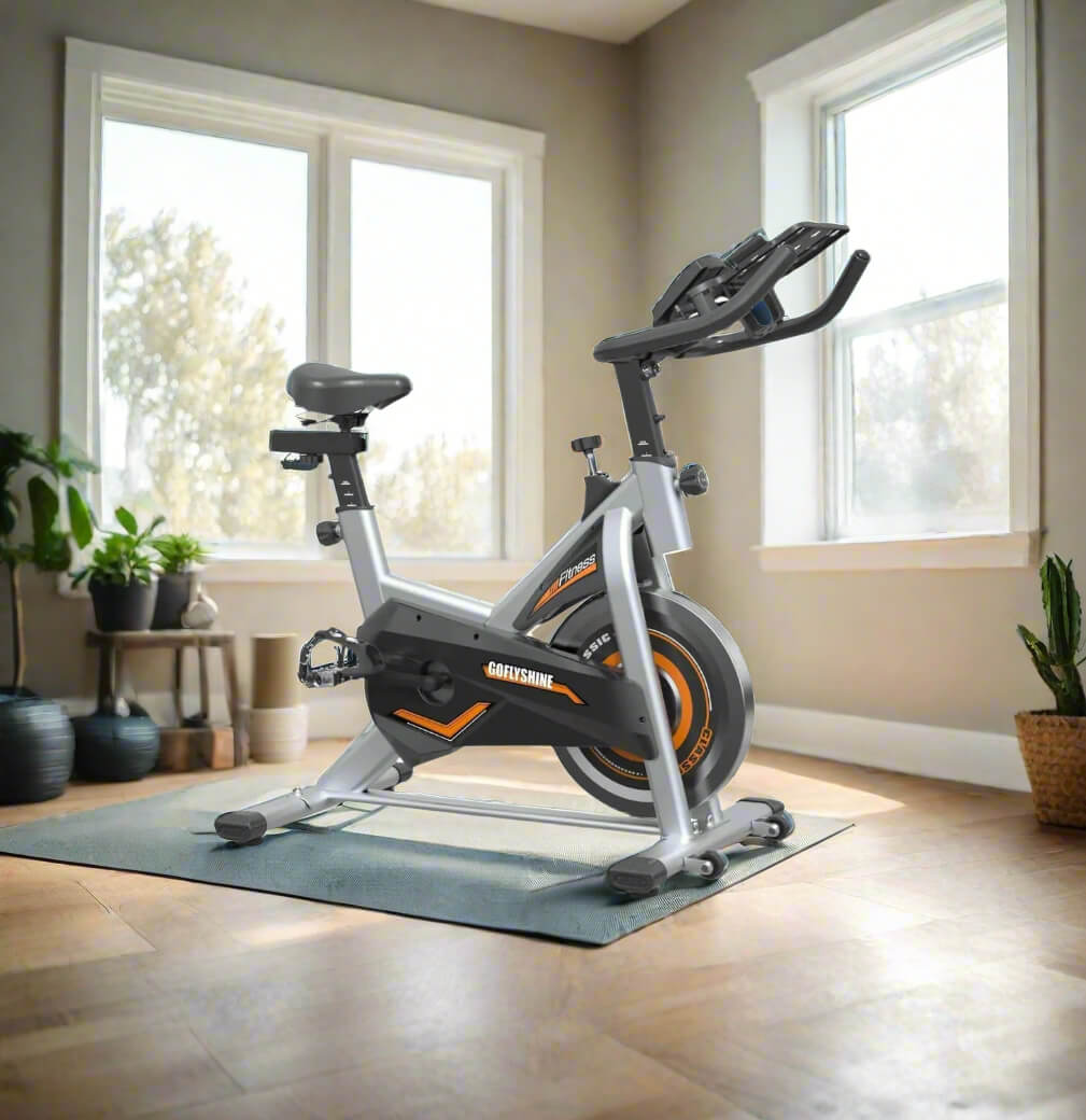 A black and orange recommended exercise bike sold by 100 Spartans