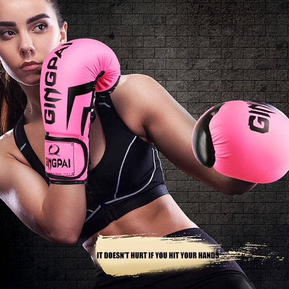 A woman sparring with a pink PU boxing gloves sold by 100 Spartans