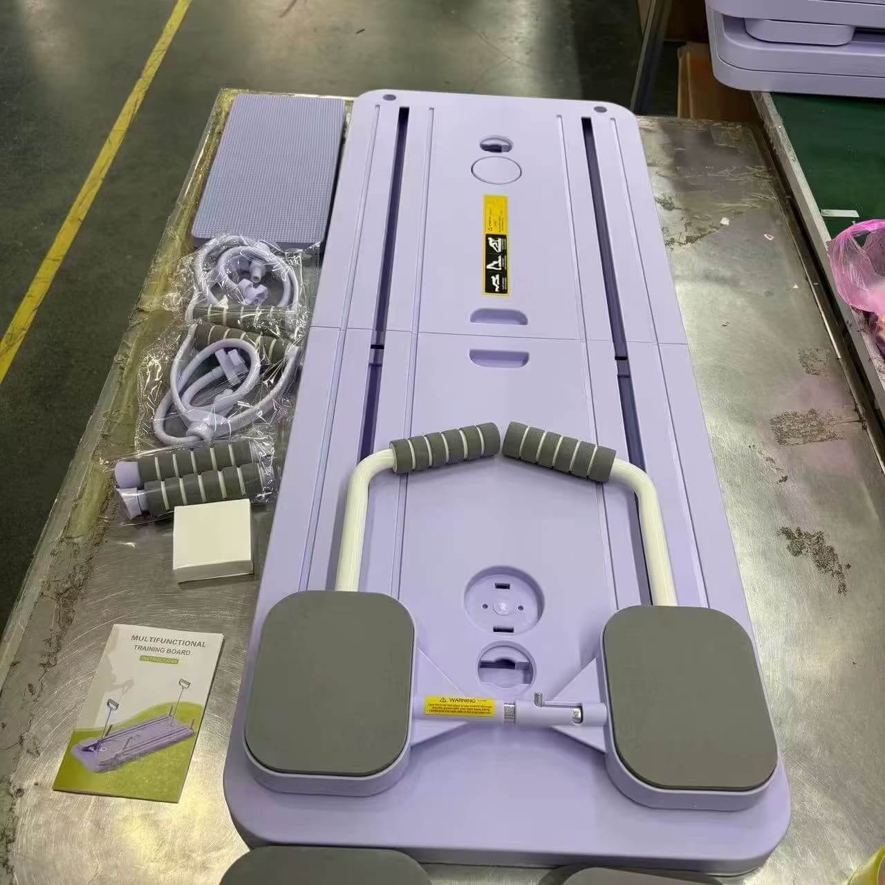 A purple Pilates Board with accessories sold by 100 Spartans