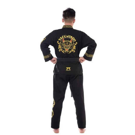 Person wearing a black Taekwondo uniform with gold designs on a white background