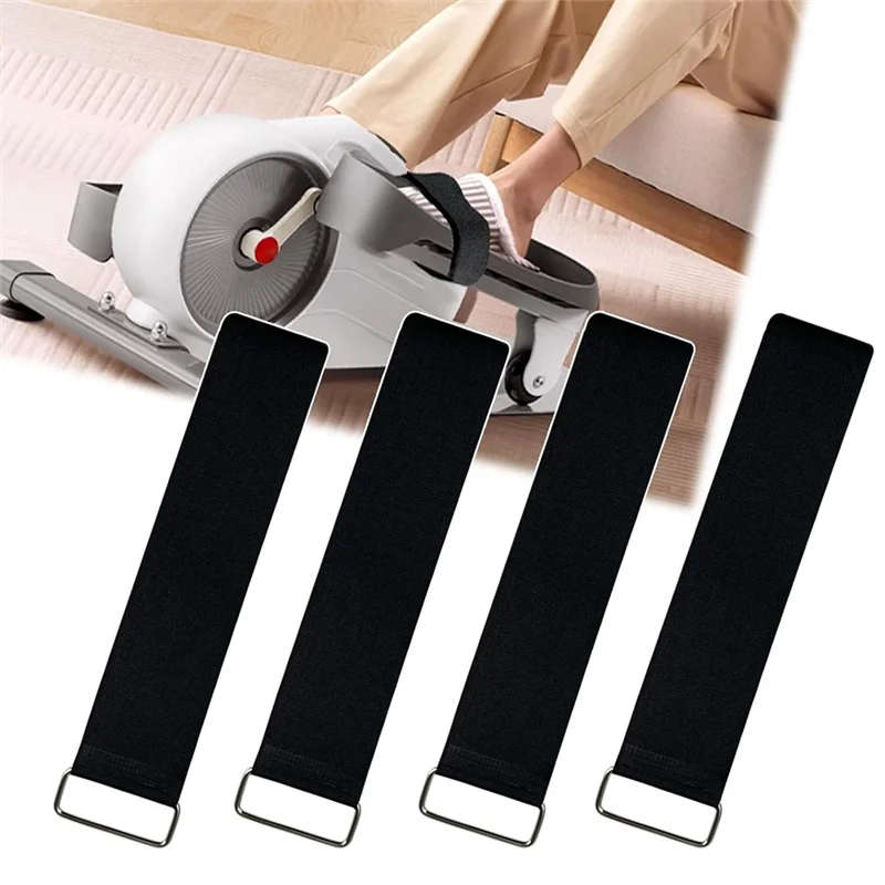 Black bike pedal straps in front of a person using a home exercise bike.