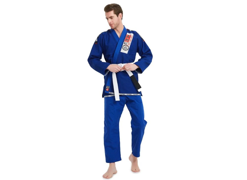 Person wearing a blue martial arts uniform with a white belt on a white background