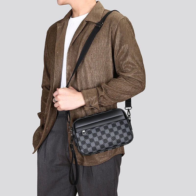 Person wearing a brown jacket with a black and gray checkered leather toiletry bag on a light gray background