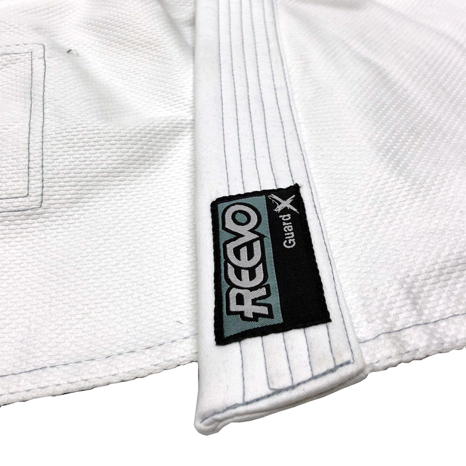 White BJJ gi with REEVO label on a white background