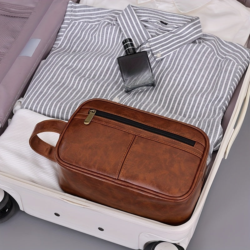 Brown leather toiletry bag on a suitcase with a striped shirt and perfume bottle.