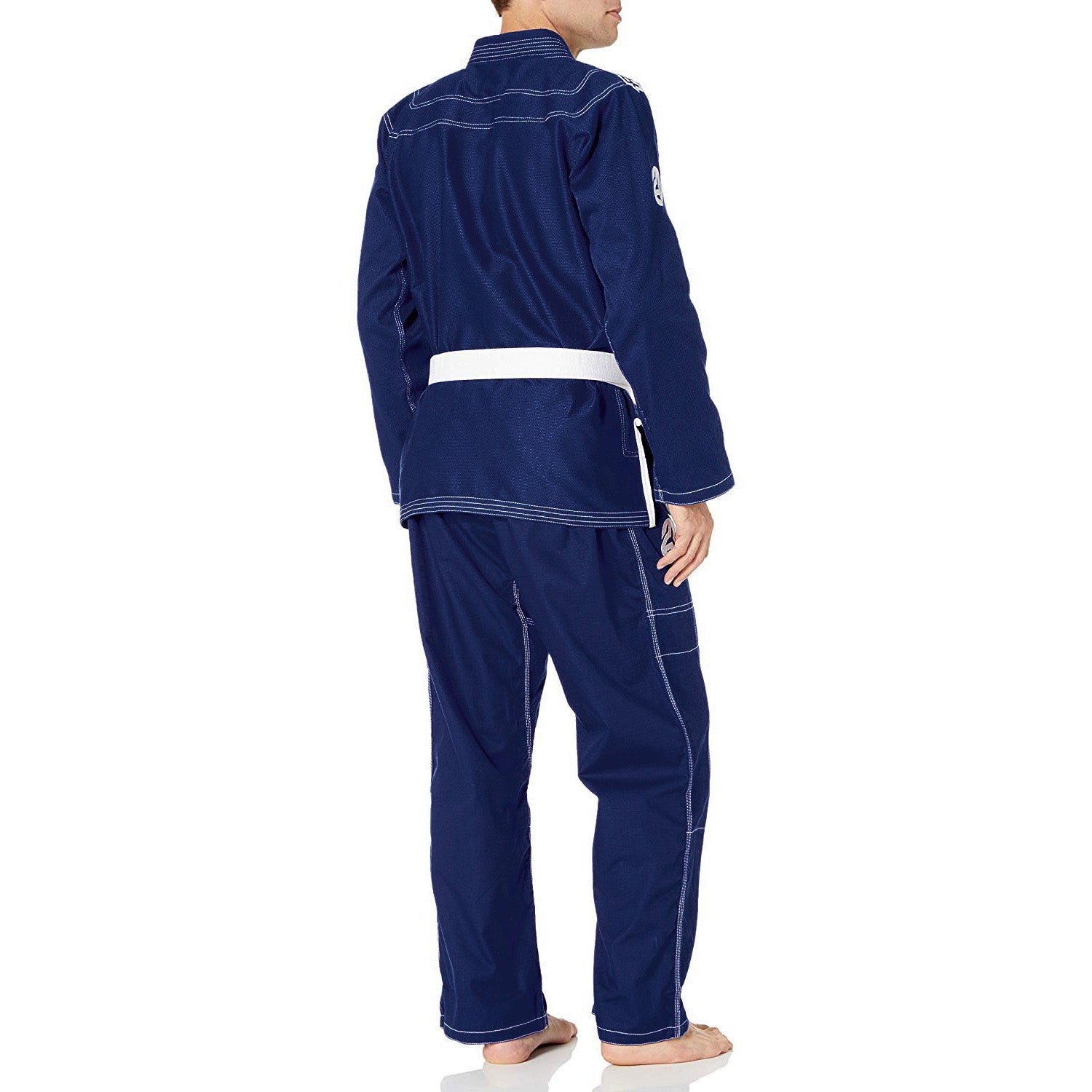 Person wearing a navy blue tracksuit with white accents on a white background