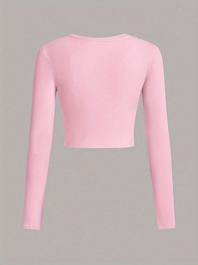 Pink long-sleeve crop top on a gray background