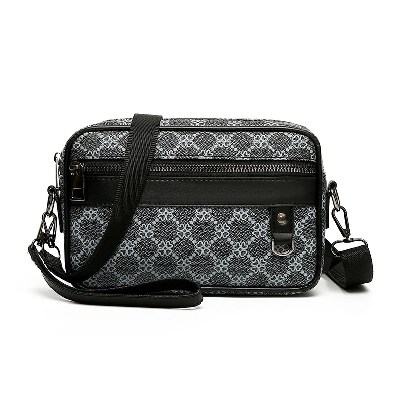 Black and white patterned leather toiletry bag with a shoulder strap on a white background