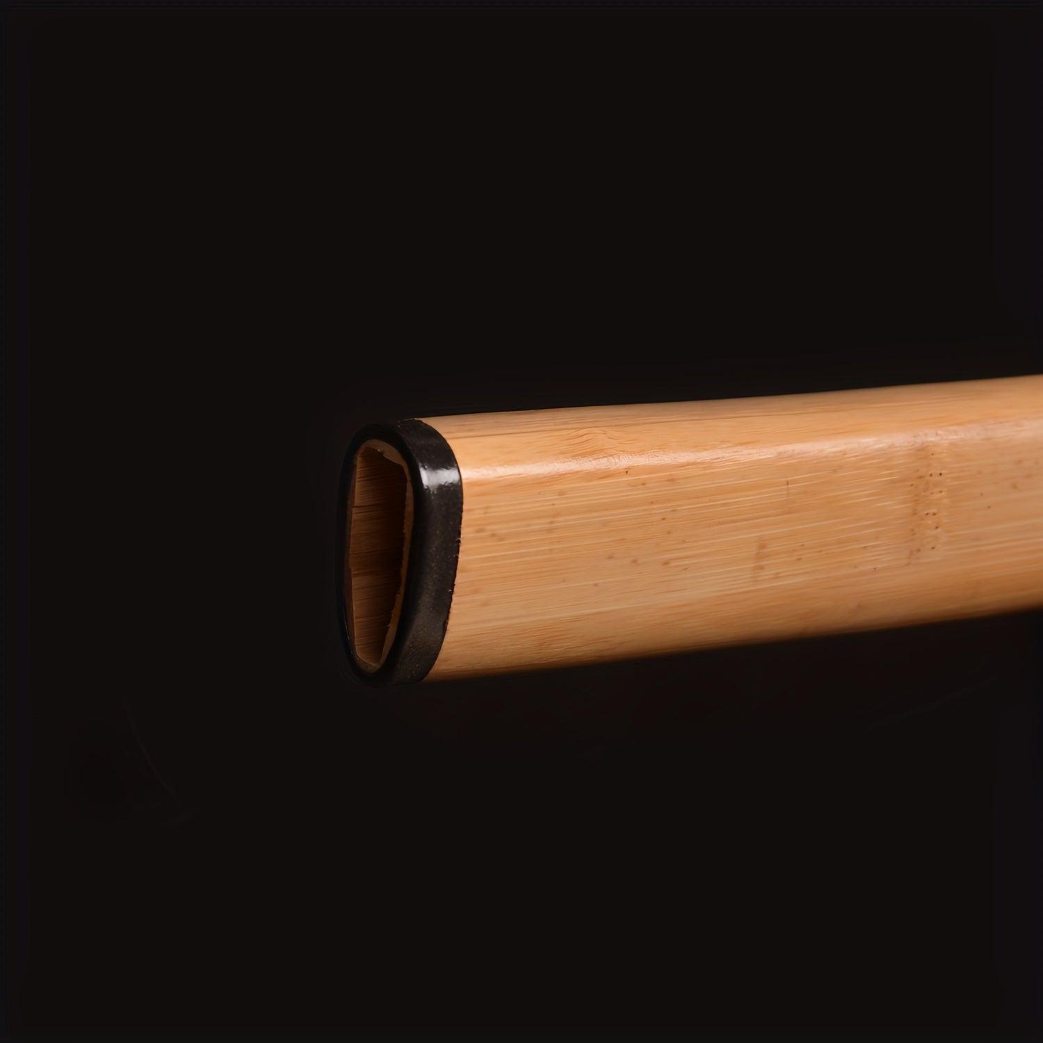 Bamboo scabbard with black interior on a black background