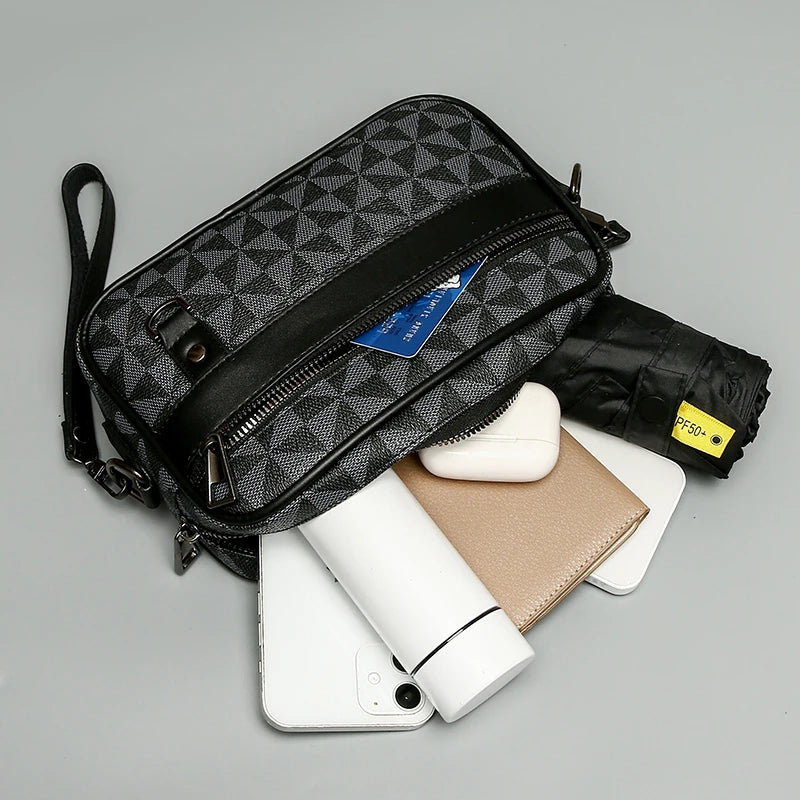 Black geometric patterned toiletry bag with travel items on a gray background