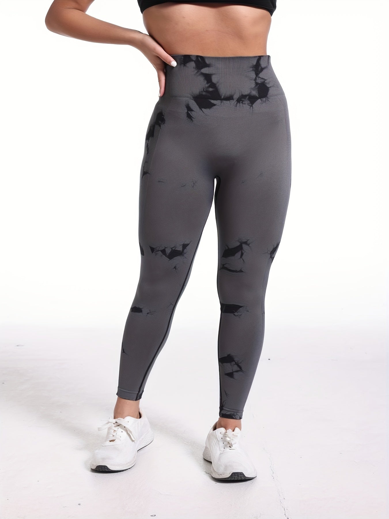 The frontview of a woman wearing a grey high waisted yoga leggings sold by 100 Spartans
