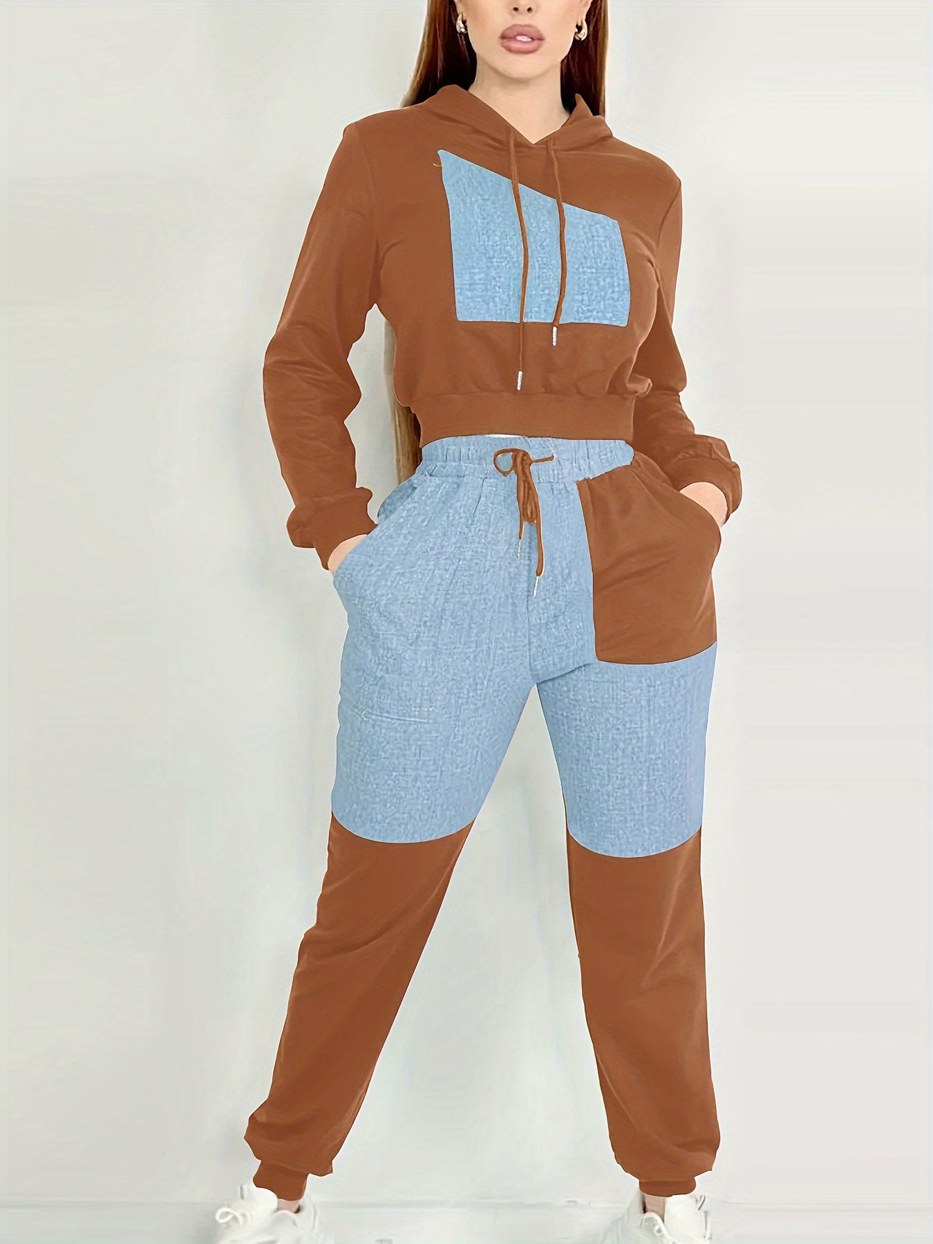 Two-tone brown and blue women's luxury tracksuit set on a white background