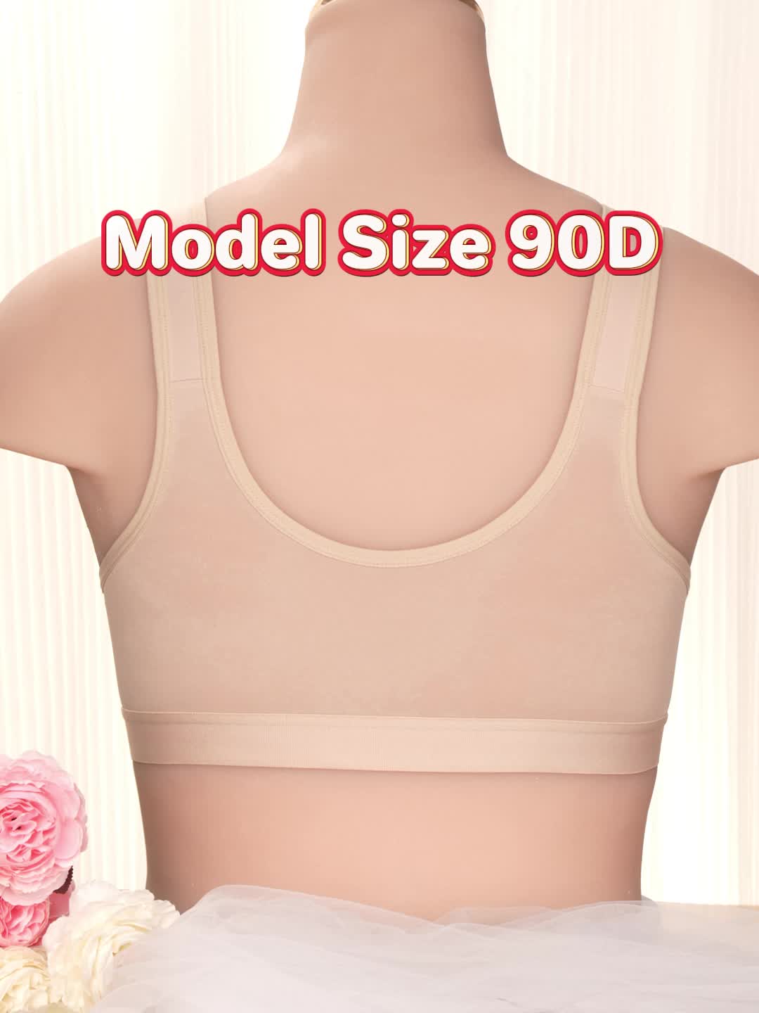 The back view of a woman wearing a black sports bras for big chests sold by 100 Spartans with front closure and wider shoulder straps.