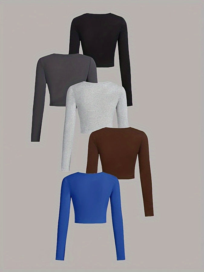 Five long-sleeve crop tops in different colors on a beige background