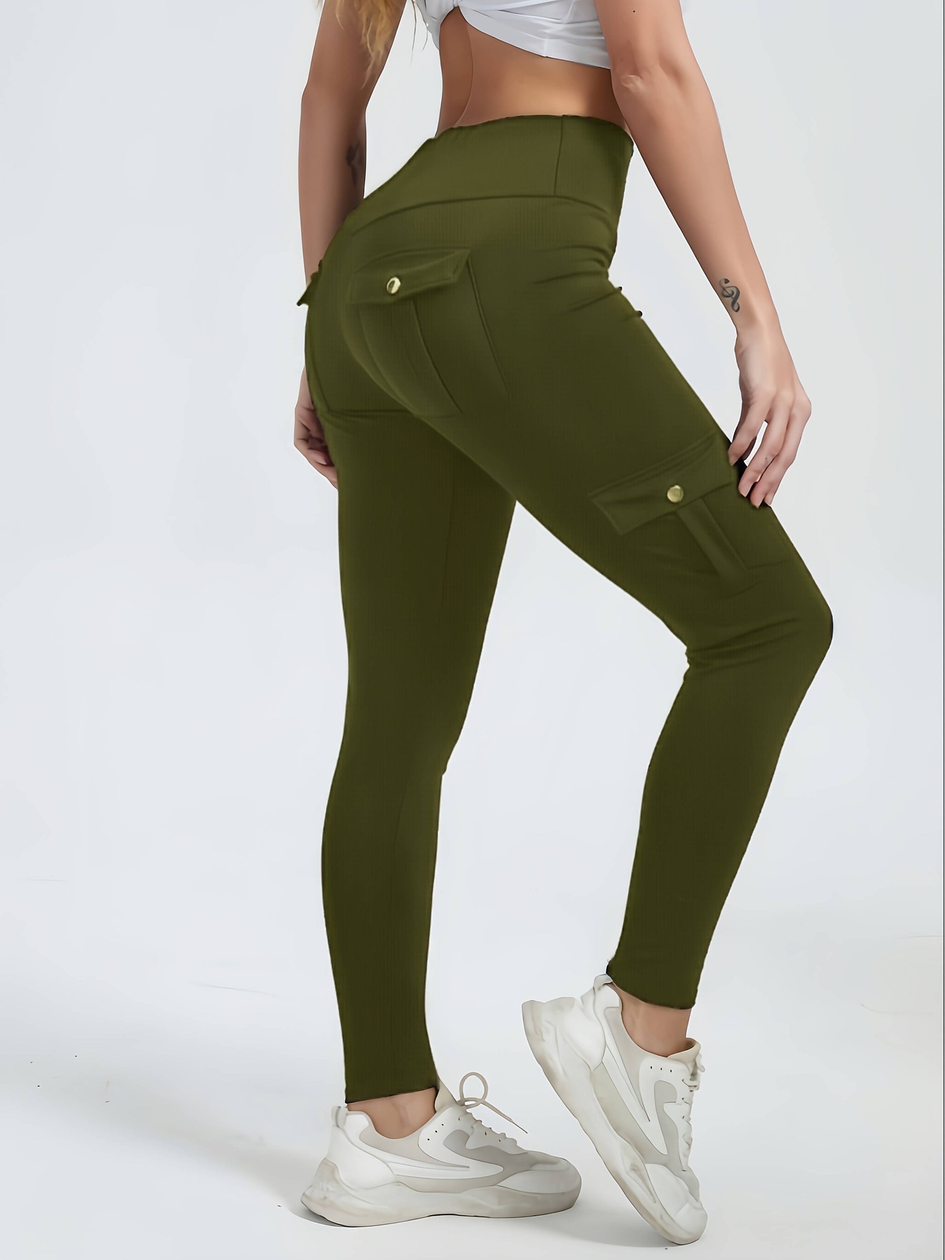 The side view of a woman wearing a pair of camouflage yoga legging sold by 100 Spartans